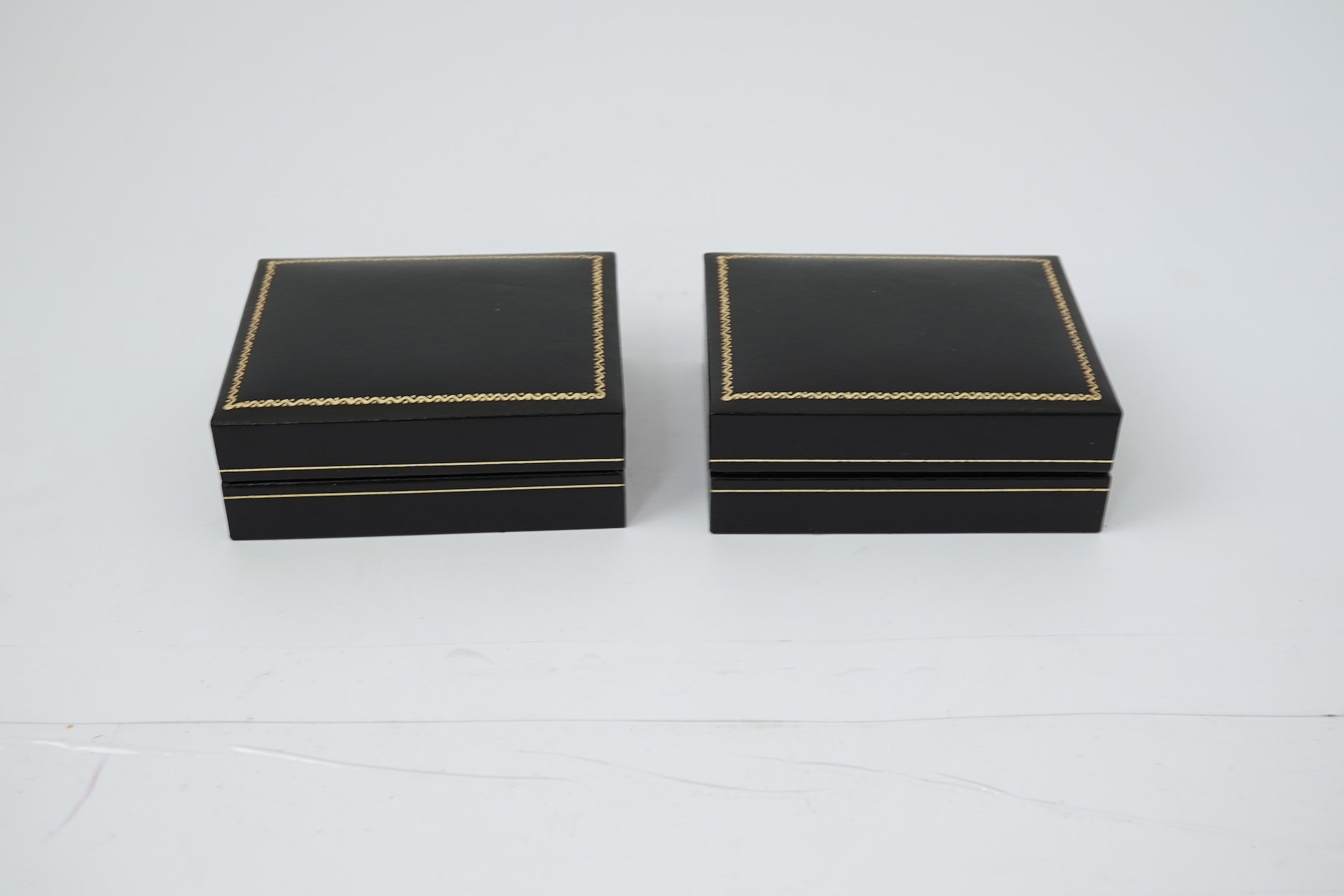 A pair of Elizabeth II silver money clips by Adrian Gerald Benney